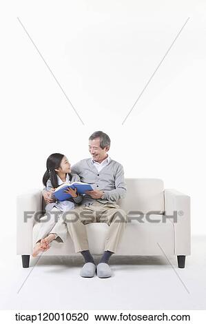 A grandfather and granddaughter reading a book View Large Photo Image Stock Image - A grandfather and granddaughter reading a book. Fotosearch