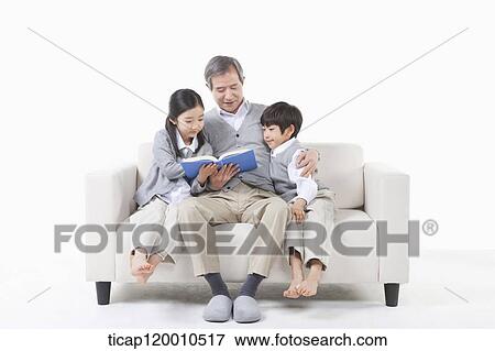 A grandfather and grandsons reading a book View Large Photo Image Stock Photo - A grandfather and grandsons reading a book. Fotosearch