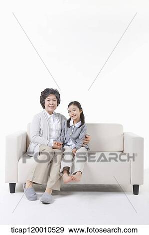 A grandmother and granddaughter on the couch View Large Photo Image Stock Photo - A grandmother and granddaughter on the couch. Fotosearch