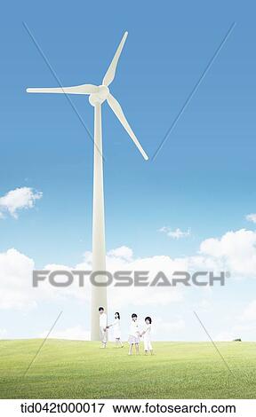 A happy family and wind power plant on the green field View Large Photo Image Stock Photo - A happy family and wind power plant on the green field. Fotosearch