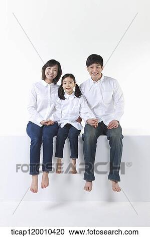 Stock Image - A happy family holding hands together. Fotosearch