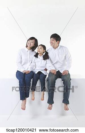 A happy family looking at the sky View Large Photo Image Stock Image - A happy family looking at the sky . Fotosearch