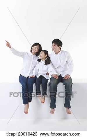 A happy family looking at the sky View Large Photo Image Stock Image - A happy family looking at the sky . Fotosearch