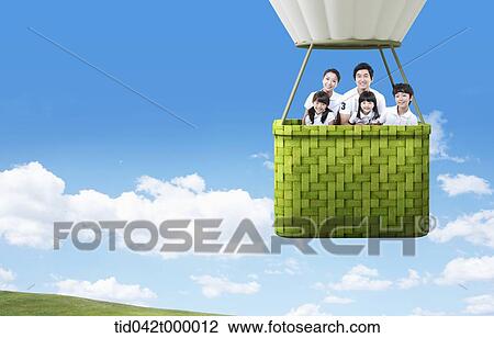 A happy family on the green hot-air balloon View Large Photo Image Stock Image - A happy family on the green hot-air balloon. Fotosearch
