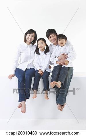 Stock Image - A happy family sitting together. Fotosearch