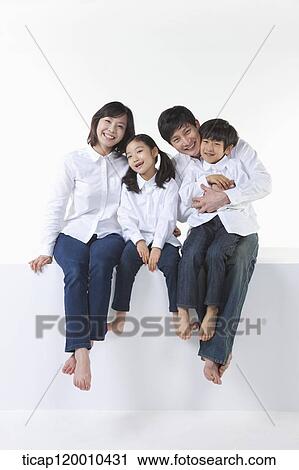A happy family sitting together View Large Photo Image Stock Image - A happy family sitting together. Fotosearch