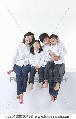A happy family sitting together View Large Photo Image Stock Image - A happy family sitting together. Fotosearch