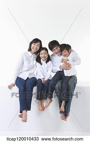 Stock Image - A happy family sitting together. Fotosearch