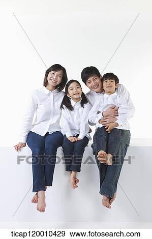 A happy family sitting together View Large Photo Image Stock Photo - A happy family sitting together. Fotosearch