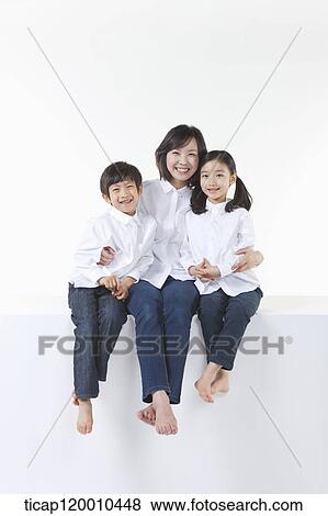 Stock Photo - A happy family smiling together. Fotosearch
