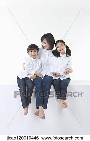 A happy family smiling together View Large Photo Image Stock Photograph - A happy family smiling together. Fotosearch