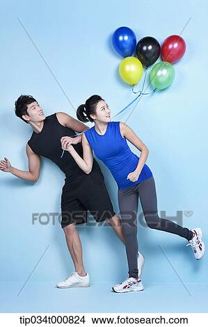 A jogging man and woman with colorful balloons View Large Photo Image Picture - A jogging man and woman with colorful balloons. Fotosearch