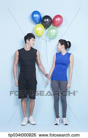 A jogging man and woman with colorful balloons View Large Photo Image Stock Photograph - A jogging man and woman with colorful balloons. Fotosearch