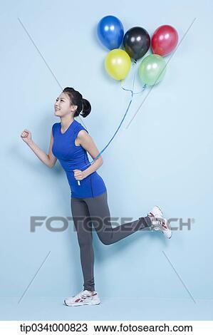 A jogging woman with colorful balloons View Large Photo Image Stock Image - A jogging woman with colorful balloons. Fotosearch