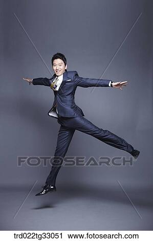 A jumping businessman with his arms open View Large Photo Image Stock Image - A jumping businessman with his arms open. Fotosearch