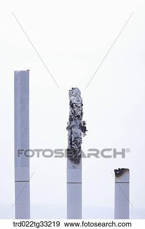Stock Photo - A long cigarette and shorter cigarettes. Fotosearch