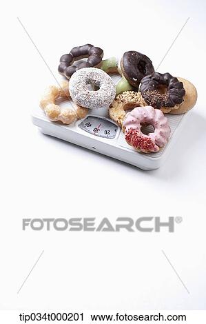 A lot of donut on the scale View Large Photo Image Stock Image - A lot of donut on the scale. Fotosearch