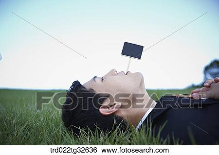 Stock Photograph - A lying businessman and a black board. Fotosearch