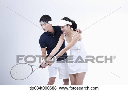 A male player coaching the female tennis player View Large Photo Image Stock Photo - A male player coaching the female tennis player. Fotosearch