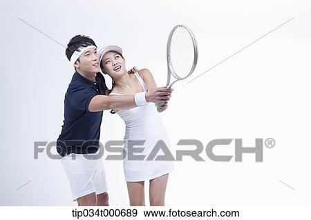 A male player coaching the female tennis player View Large Photo Image Stock Photo - A male player coaching the female tennis player. Fotosearch
