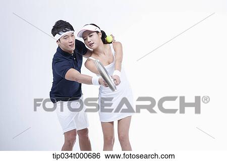 Stock Photograph - A male player coaching the female tennis player. Fotosearch