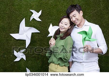 A man and woman with green and white pinwheels View Large Photo Image Picture - A man and woman with green and white pinwheels. Fotosearch