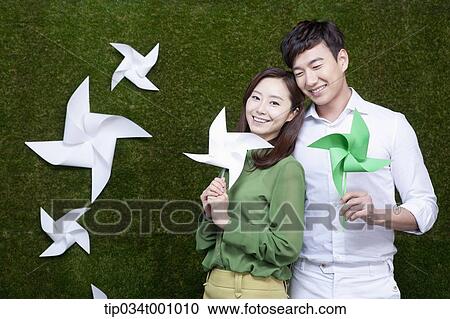 A man and woman with green and white pinwheels View Large Photo Image Stock Image - A man and woman with green and white pinwheels. Fotosearch