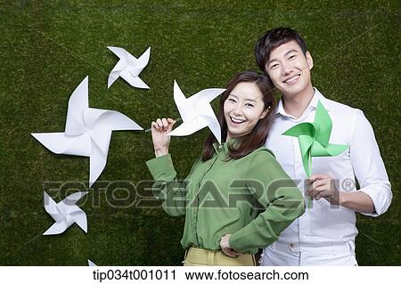 A man and woman with green and white pinwheels View Large Photo Image Stock Image - A man and woman with green and white pinwheels. Fotosearch