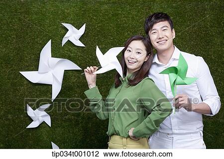 A man and woman with green and white pinwheels View Large Photo Image Stock Image - A man and woman with green and white pinwheels. Fotosearch