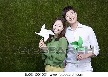 A man and woman with green and white pinwheels View Large Photo Image Stock Image - A man and woman with green and white pinwheels. Fotosearch