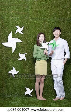 Stock Photo - A man and woman with green and white pinwheels. Fotosearch