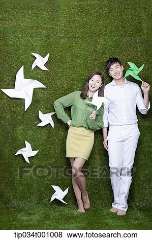 Stock Photo - A man and woman with green and white pinwheels. Fotosearch