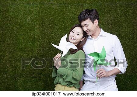A man and woman with green and white pinwheels View Large Photo Image Stock Photo - A man and woman with green and white pinwheels. Fotosearch