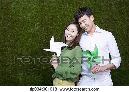 A man and woman with green and white pinwheels View Large Photo Image Stock Photo - A man and woman with green and white pinwheels. Fotosearch