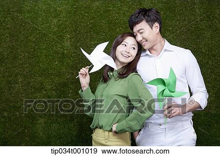 A man and woman with green and white pinwheels View Large Photo Image Stock Photo - A man and woman with green and white pinwheels. Fotosearch