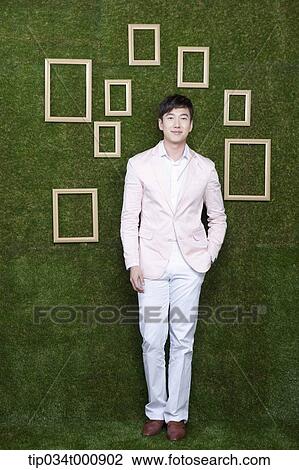 A man and wooden frames on the green wall View Large Photo Image Stock Image - A man and wooden frames on the green wall. Fotosearch