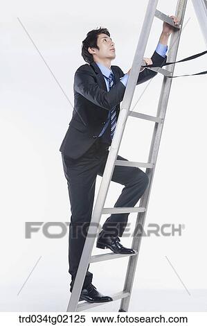 Stock Photography - A man climbing up the ladder. Fotosearch