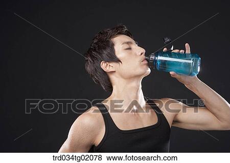 A man drinking the water View Large Photo Image Stock Photo - A man drinking the water. Fotosearch
