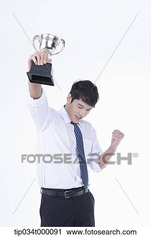 A man excited with a trophy View Large Photo Image Stock Image - A man excited with a trophy. Fotosearch