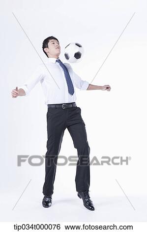 Stock Photograph - A man getting a soccer ball with his chest. Fotosearch