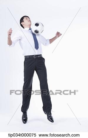 Stock Photography - A man getting a soccer ball with his chest. Fotosearch