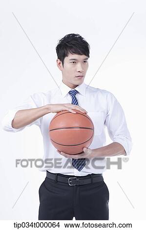 Picture - A man holding a basketball. Fotosearch