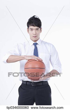 A man holding a basketball View Large Photo Image Stock Image - A man holding a basketball. Fotosearch