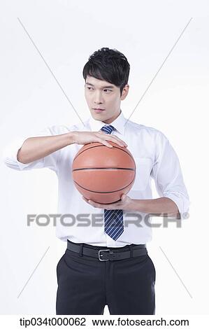 A man holding a basketball View Large Photo Image Stock Image - A man holding a basketball. Fotosearch
