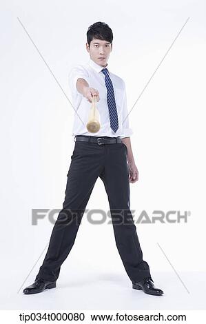 A man holding a bat View Large Photo Image Stock Image - A man holding a bat. Fotosearch