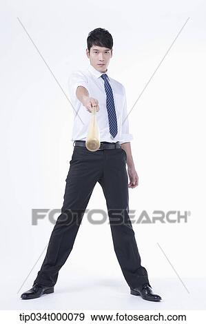 Stock Photo - A man holding a bat. Fotosearch