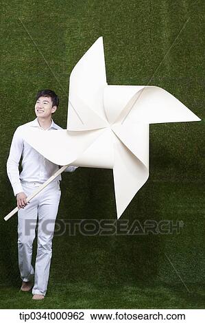 A man holding a white pinwheel View Large Photo Image Stock Image - A man holding a white pinwheel. Fotosearch