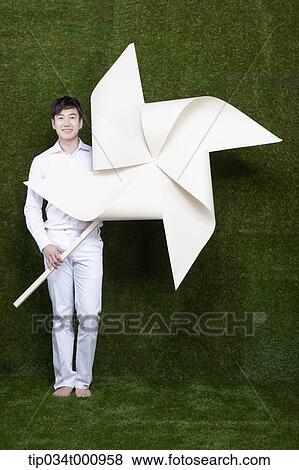 Stock Photo - A man holding a white pinwheel. Fotosearch