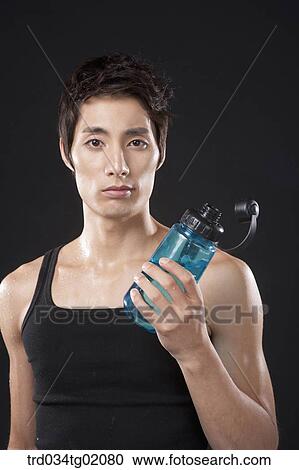 A man holding the bottle of water View Large Photo Image Stock Image - A man holding the bottle of water. Fotosearch