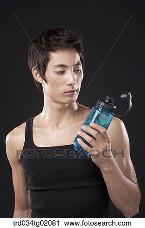A man holding the bottle of water View Large Photo Image Stock Image - A man holding the bottle of water. Fotosearch